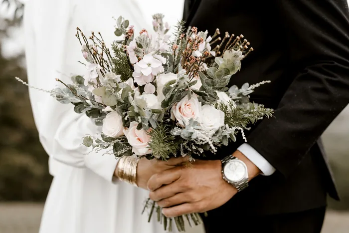 Bride and groom with a wedding bouquet at an outdoor ceremony in Spain