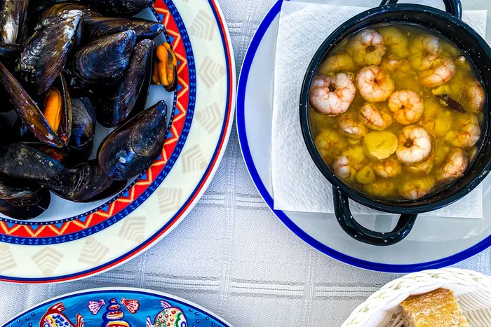 Overhead view of traditional Spanish seafood dishes on a table