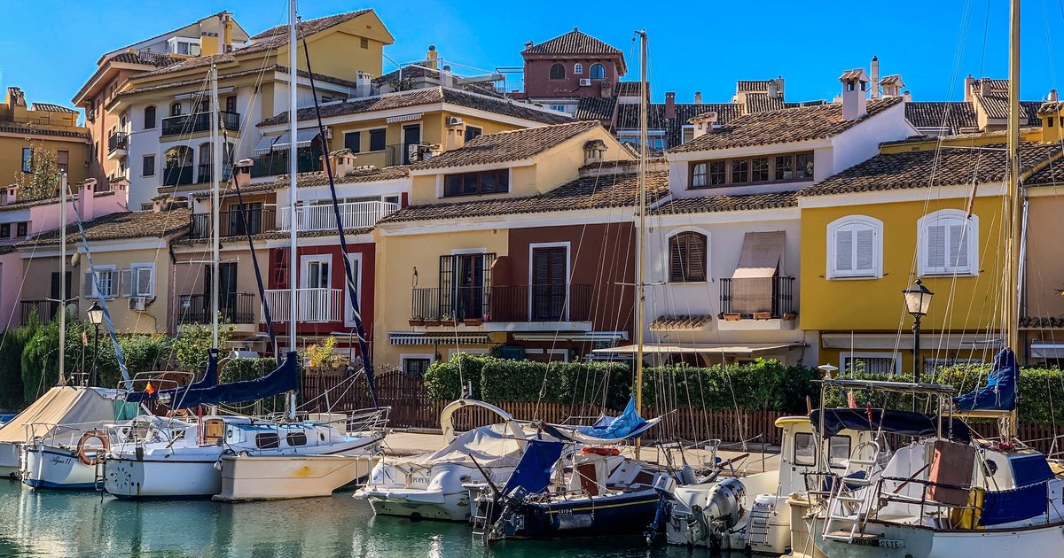 Mediterranean marina with sailboats and coastal architecture, Spain
